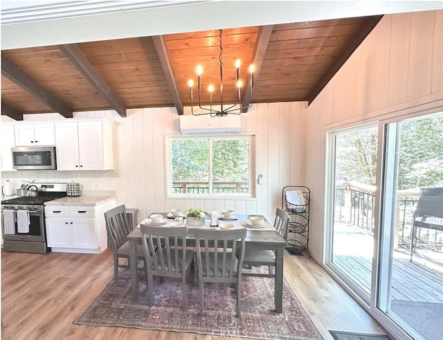 dining room featuring light hardwood / wood-style flooring, lofted ceiling, and a healthy amount of sunlight