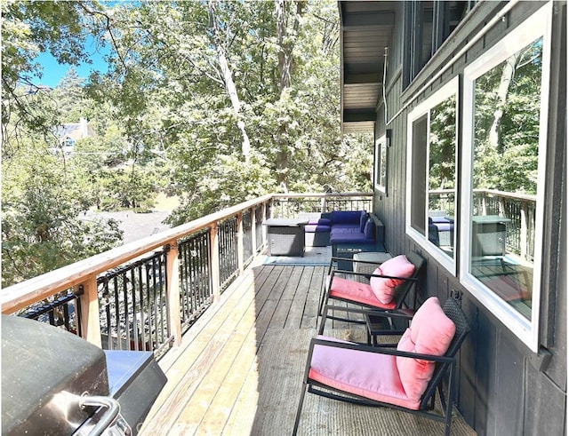 wooden terrace with an outdoor hangout area