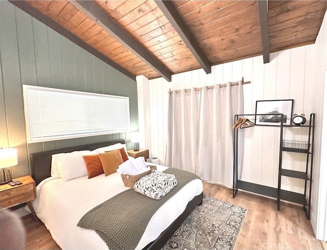 bedroom featuring wood ceiling, light wood-type flooring, vaulted ceiling with beams, and wood walls