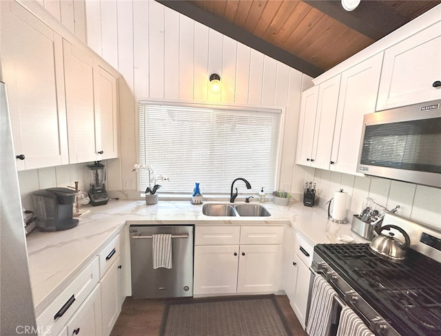 kitchen featuring light stone counters, white cabinets, wood ceiling, sink, and appliances with stainless steel finishes