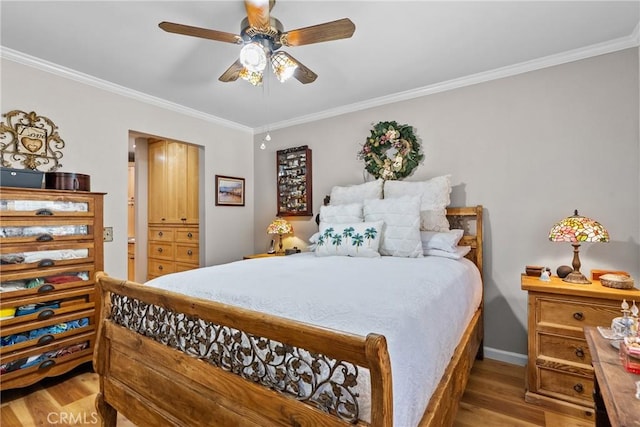 bedroom with light hardwood / wood-style flooring, ceiling fan, and ornamental molding