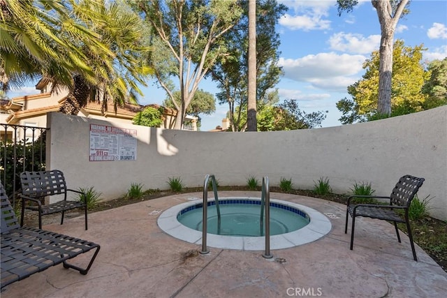 view of swimming pool featuring a community hot tub