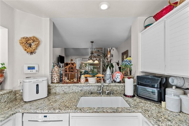 kitchen with dishwasher, white cabinets, decorative light fixtures, and sink