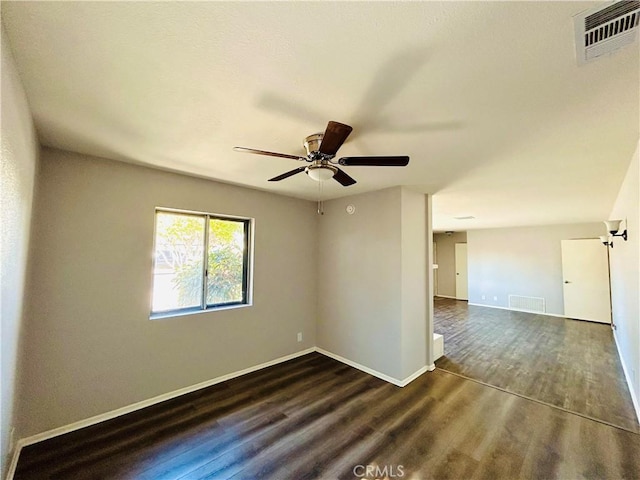 spare room with dark hardwood / wood-style floors and ceiling fan