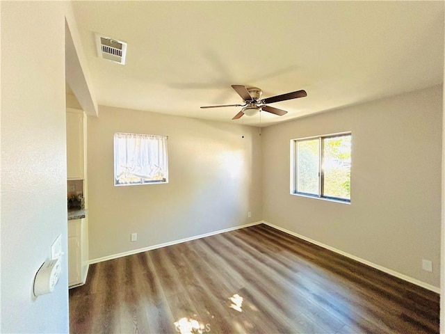 unfurnished room with ceiling fan and dark hardwood / wood-style flooring