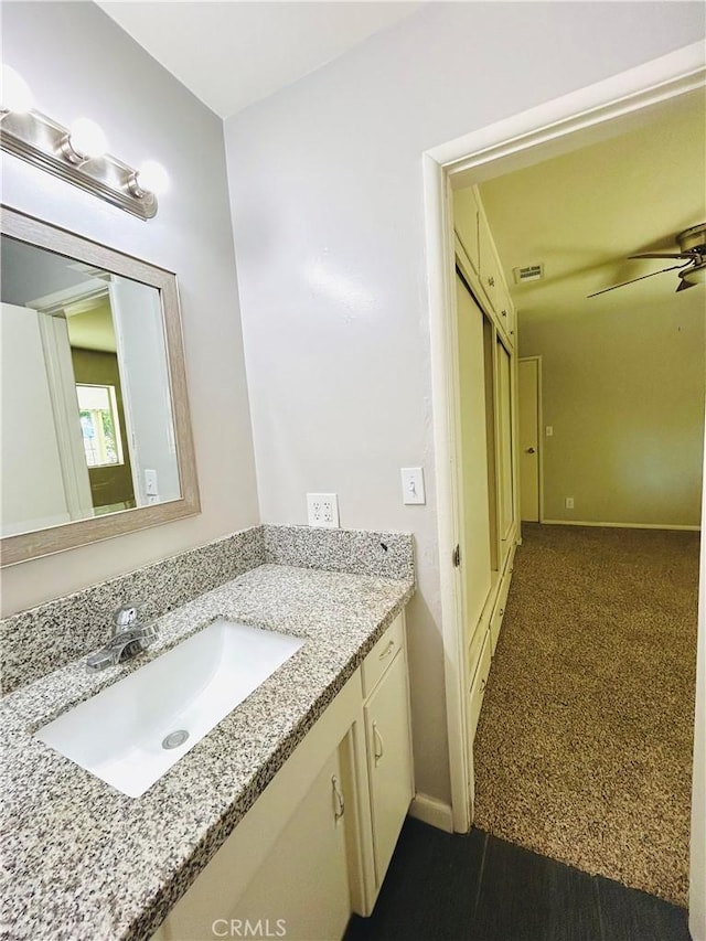 bathroom with ceiling fan and vanity