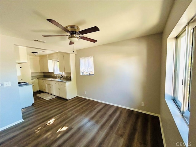 kitchen with ceiling fan, plenty of natural light, white cabinets, and dark wood-type flooring