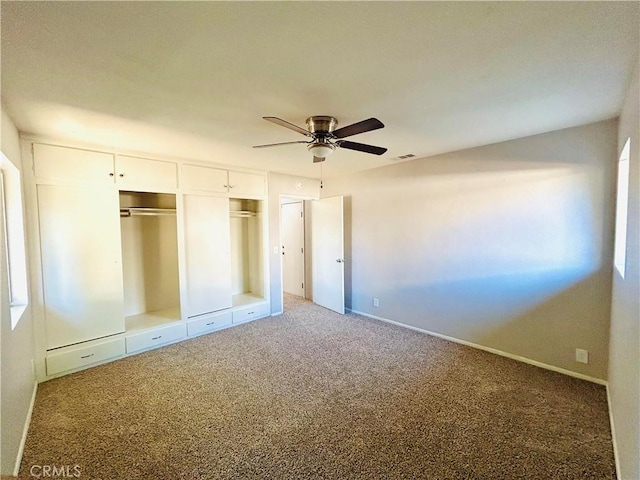 unfurnished bedroom featuring ceiling fan and carpet floors