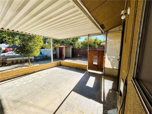 view of patio / terrace featuring a storage unit