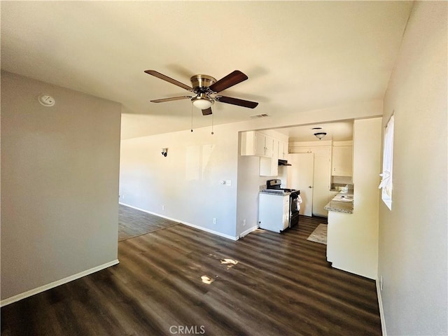 unfurnished living room featuring ceiling fan and dark wood-type flooring