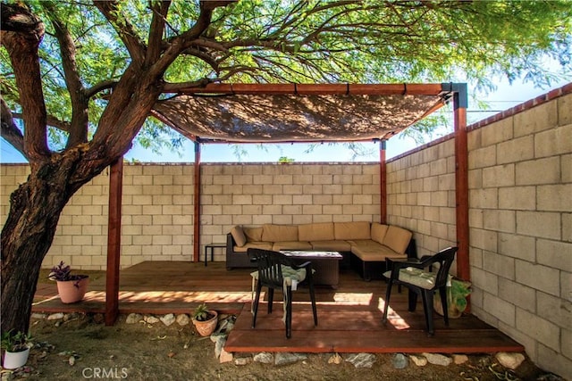 view of patio with an outdoor living space, a fenced backyard, and a wooden deck