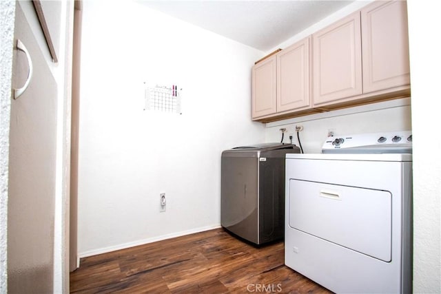 laundry room with cabinet space, separate washer and dryer, baseboards, and dark wood finished floors