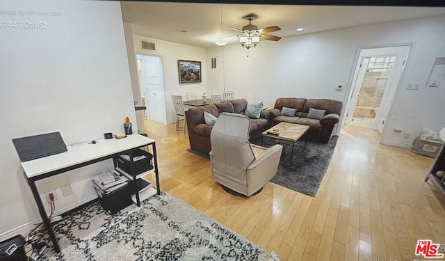 living room with ceiling fan and wood-type flooring