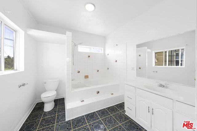 full bathroom with vanity, toilet, and tiled shower / bath