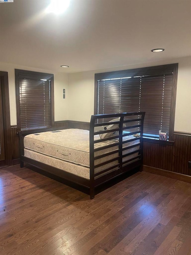 unfurnished bedroom with dark wood-type flooring