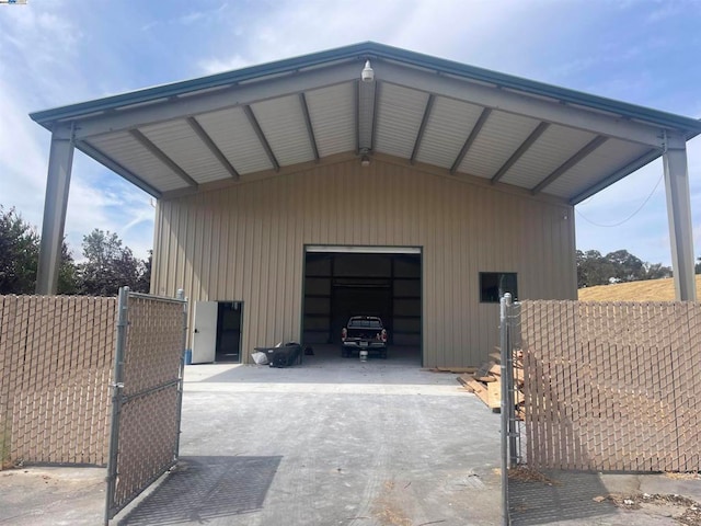 view of outdoor structure featuring a carport and a garage