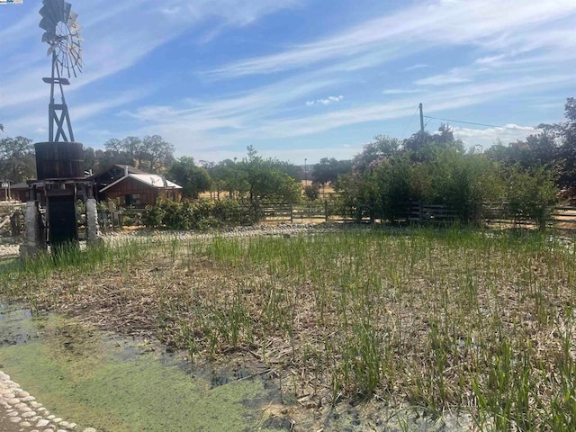 view of yard with a rural view