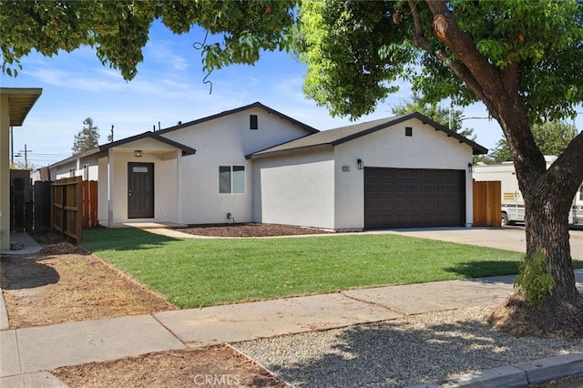 ranch-style house with a garage and a front lawn