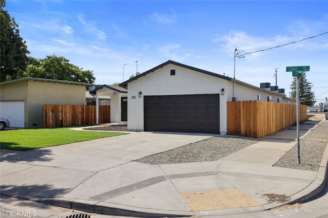 ranch-style home with a garage and a front yard