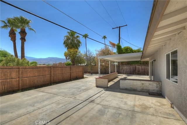 view of patio / terrace featuring a mountain view