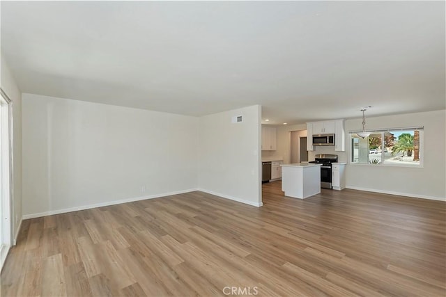 74761 Leslie Ave, Palm Desert, CA 92260 - unfurnished living room with light wood-style floors and recessed lighting
