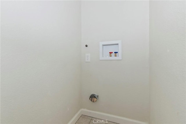 clothes washing area featuring light tile patterned floors and hookup for a washing machine