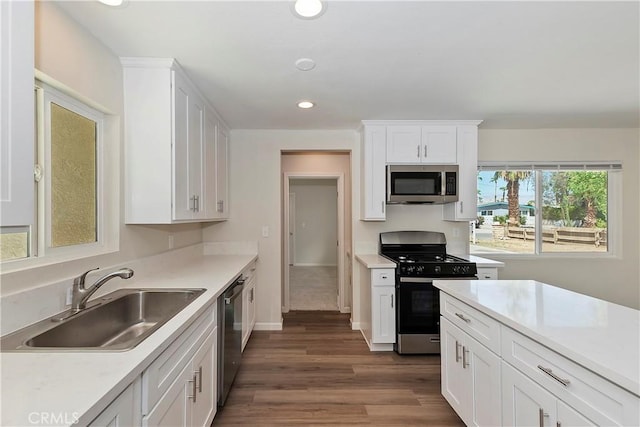 kitchen featuring dark hardwood / wood-style floors, sink, white cabinetry, and stainless steel appliances