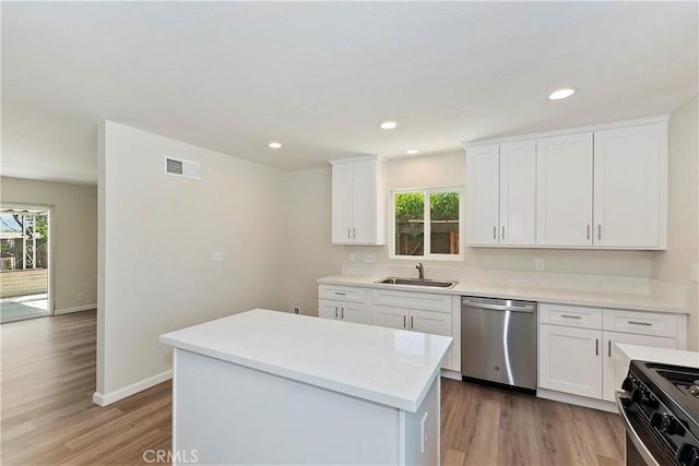 kitchen with sink, a kitchen island, stainless steel dishwasher, black range, and white cabinets