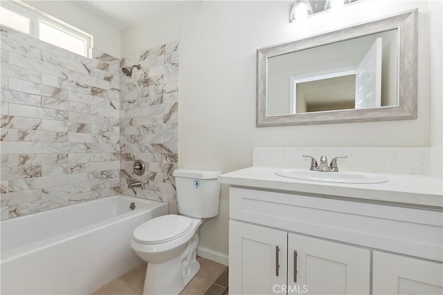 full bathroom featuring tiled shower / bath combo, toilet, and vanity