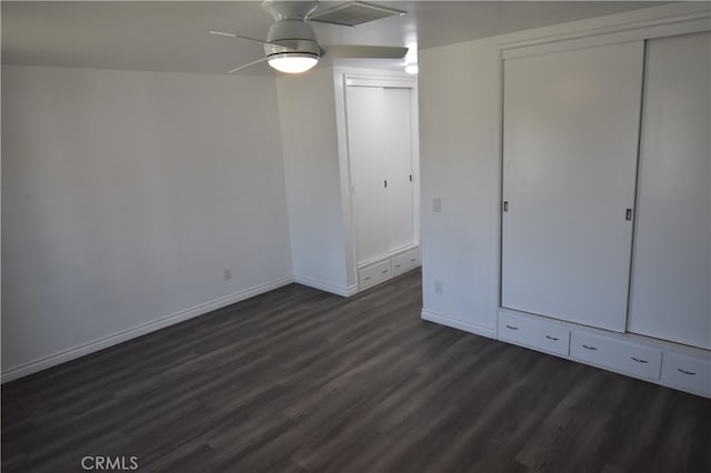 unfurnished bedroom with a closet, ceiling fan, and dark hardwood / wood-style floors