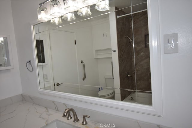 full bathroom with vanity, tiled shower / bath, and toilet