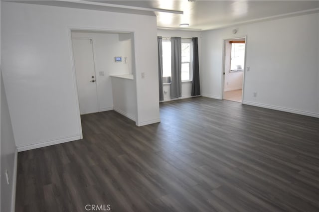 spare room with dark wood-type flooring