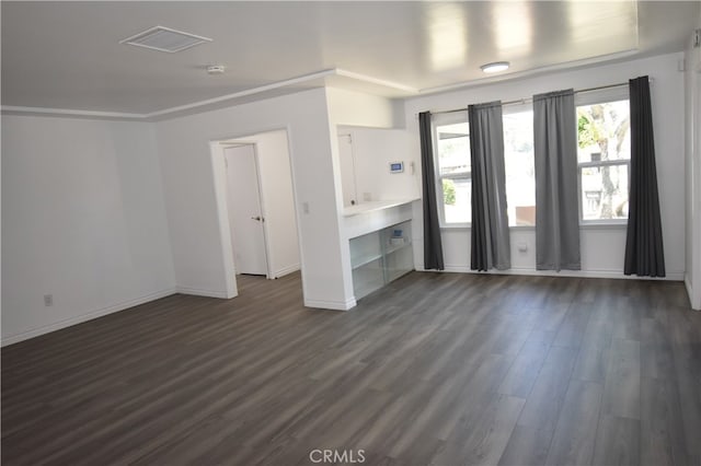 interior space featuring crown molding and dark hardwood / wood-style floors