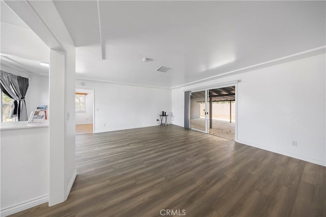 unfurnished living room with a healthy amount of sunlight, baseboards, and wood finished floors