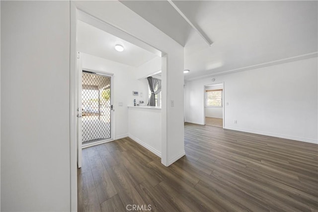 unfurnished room featuring baseboards and wood finished floors