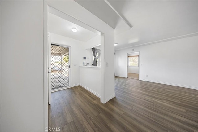 interior space featuring baseboards and wood finished floors