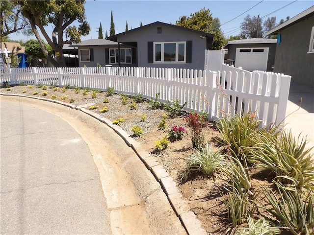 view of front facade featuring fence and stucco siding