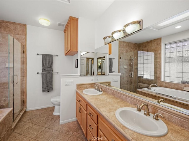 full bathroom featuring tile patterned floors, vanity, plus walk in shower, and toilet