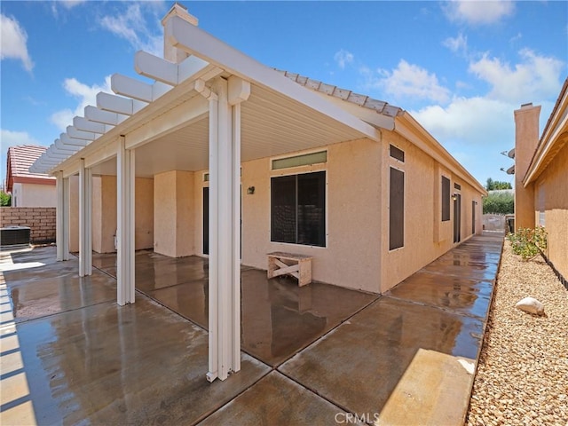 exterior space with cooling unit and a pergola