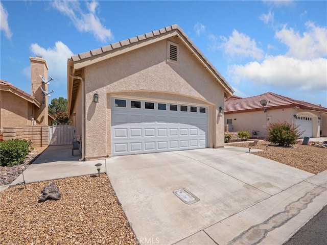 view of front of home featuring a garage and central AC