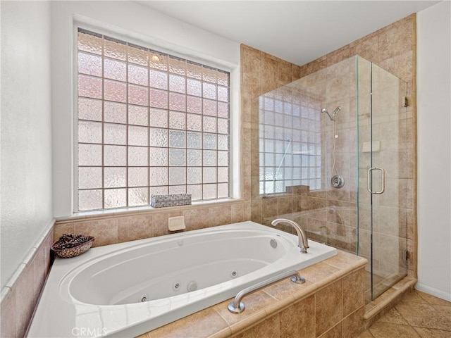 bathroom with tile patterned floors, shower with separate bathtub, and a wealth of natural light