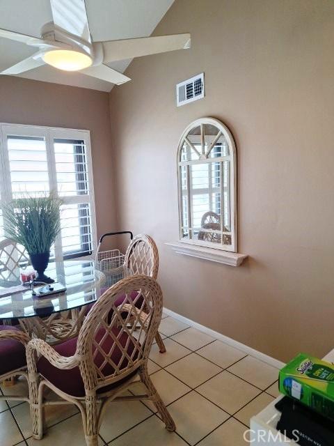 dining space with tile patterned flooring and ceiling fan