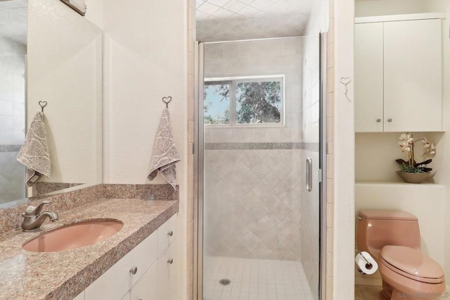 bathroom with walk in shower, vanity, and toilet