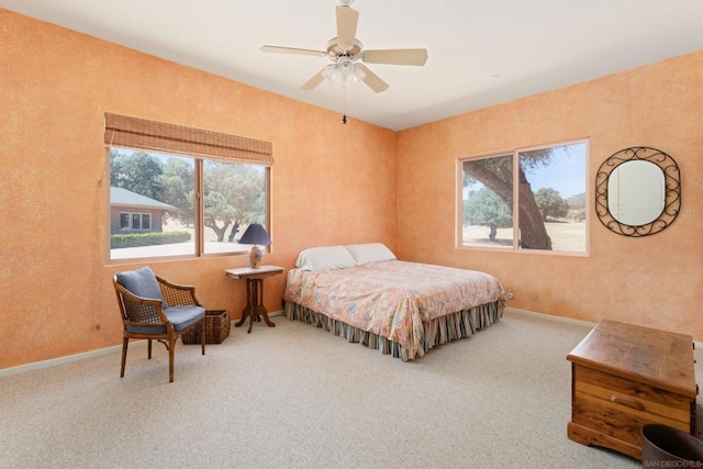 bedroom with ceiling fan and carpet floors