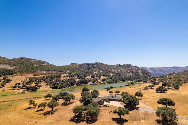 view of mountain feature featuring a water view and a rural view