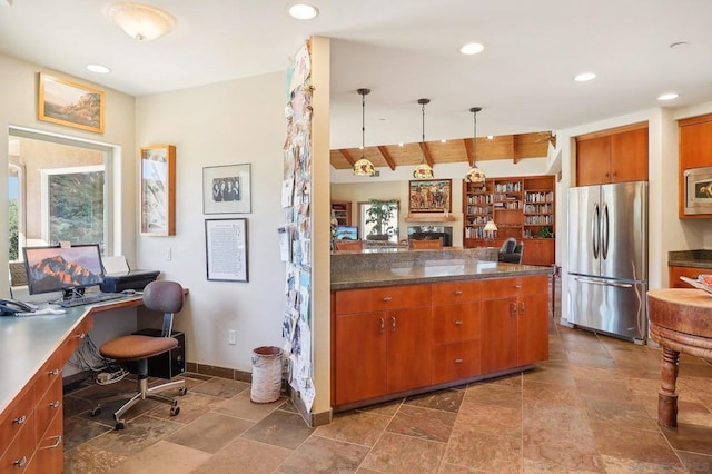 kitchen with lofted ceiling with beams, stainless steel appliances, built in desk, and hanging light fixtures