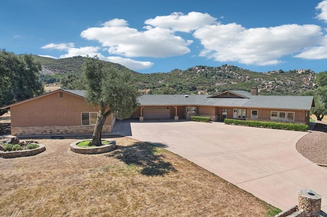 single story home with a mountain view and a garage