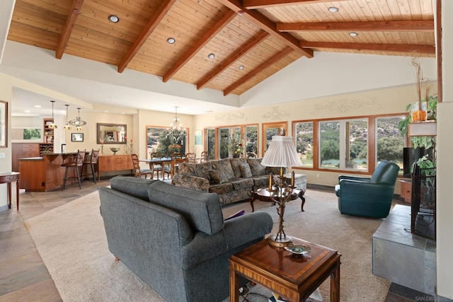 living room featuring wood ceiling, beam ceiling, an inviting chandelier, and high vaulted ceiling