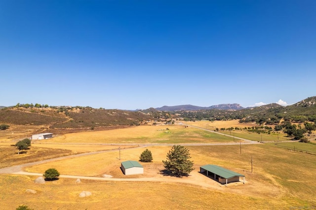 birds eye view of property with a mountain view and a rural view