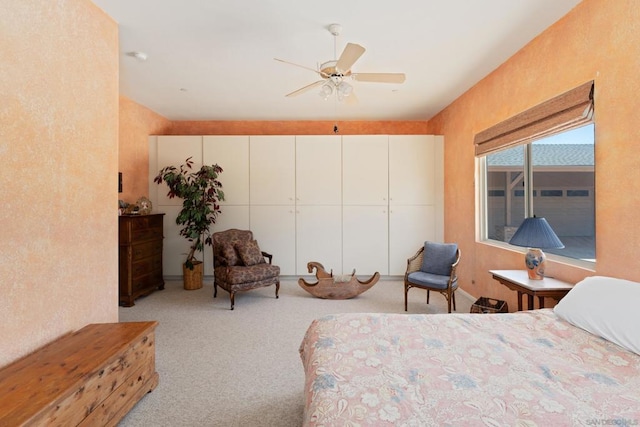 bedroom with ceiling fan and light colored carpet